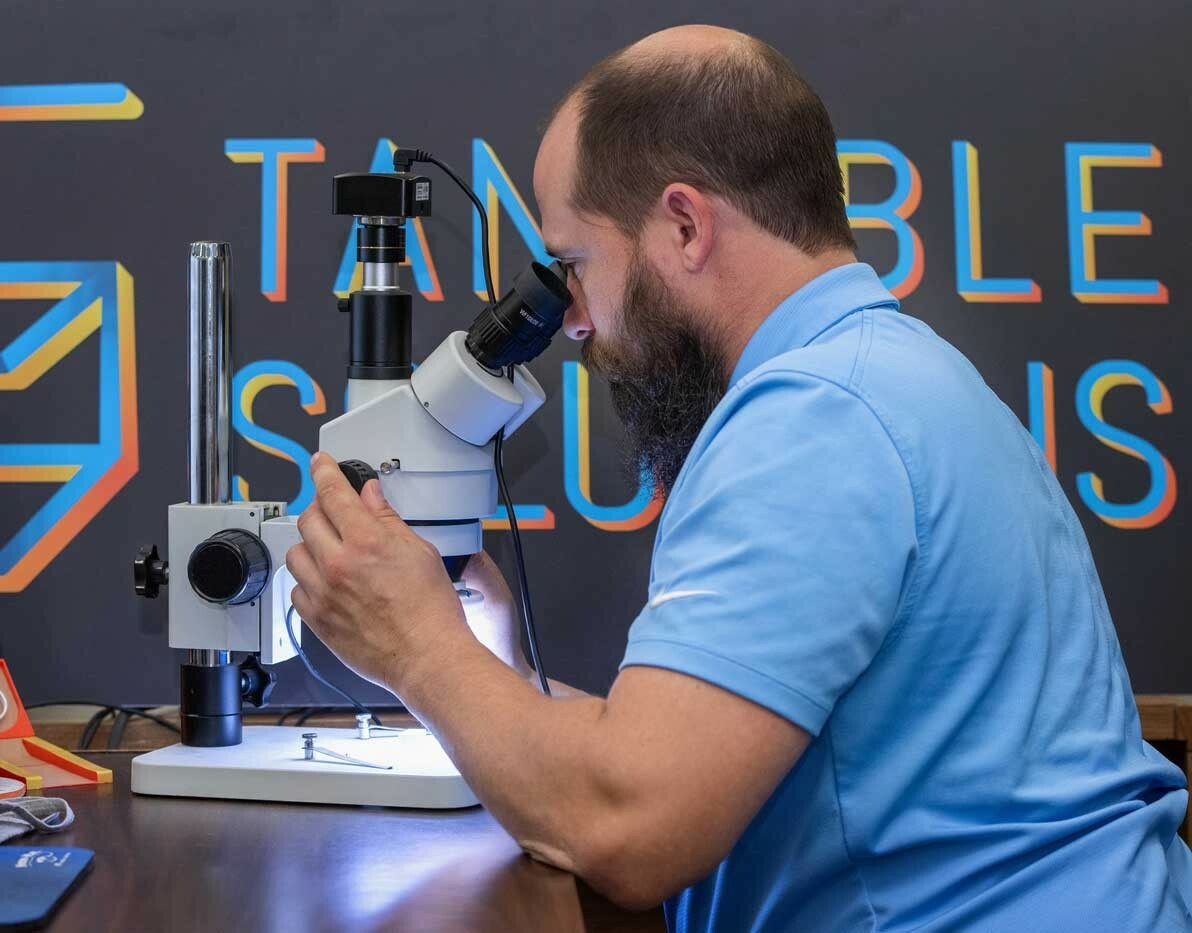 man-using-microscope